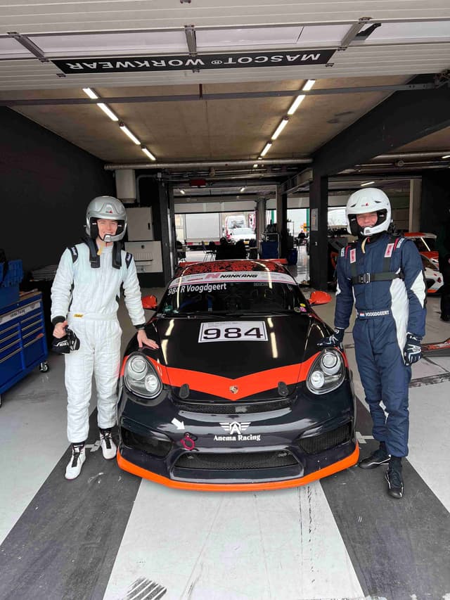 Porsche racing team in professional garage setting