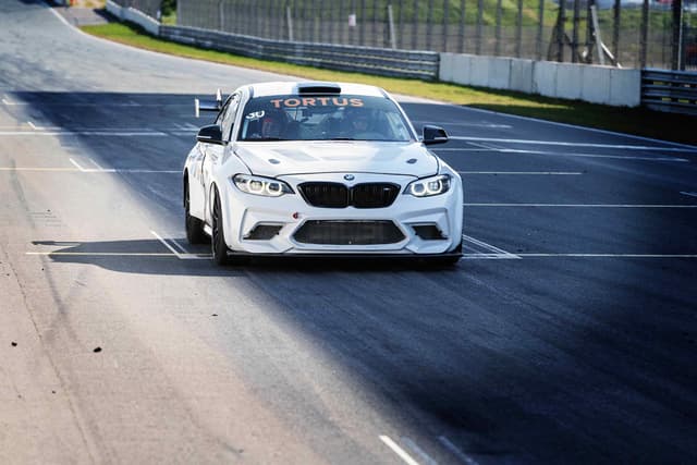 Single BMW racing car on professional track